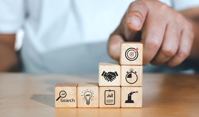 Building blocks representing data, research, strategy, and sales — key steps in CycleWerx’s results-driven marketing approach