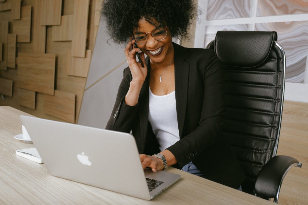 Marketer talking on phone to a customer to learn more about them

